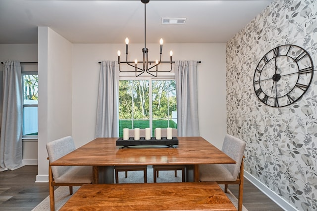 dining area featuring an inviting chandelier and dark hardwood / wood-style floors