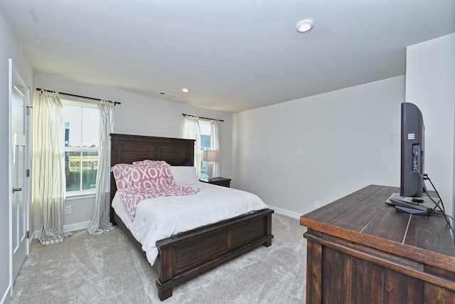 carpeted bedroom with multiple windows