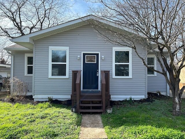 rear view of property with a yard