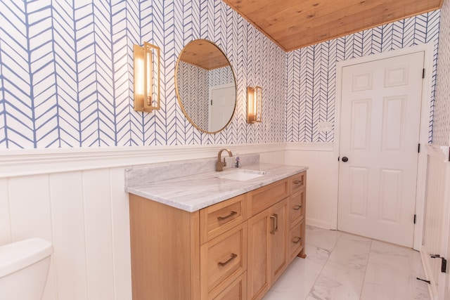 bathroom with wooden ceiling, vanity, and toilet