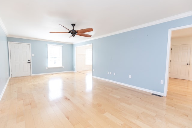 unfurnished room with ornamental molding, light hardwood / wood-style floors, and ceiling fan