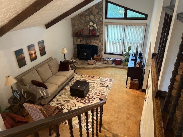 living room featuring high vaulted ceiling, beam ceiling, carpet, and a wood stove