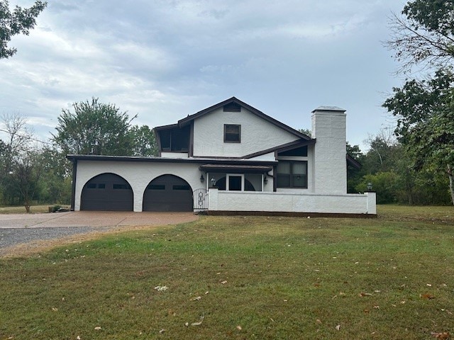 view of front of house featuring a garage and a front lawn