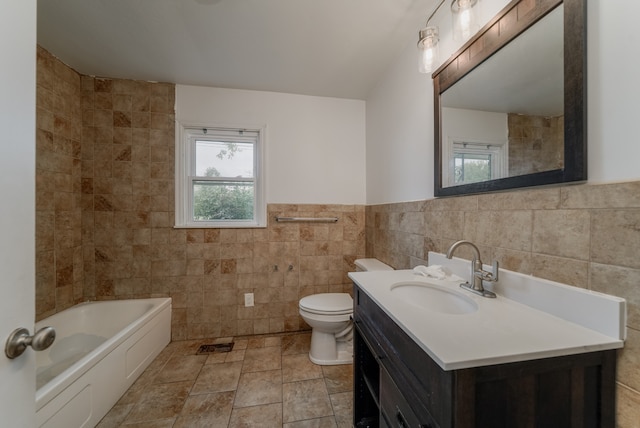 bathroom featuring tile walls, vanity, and toilet