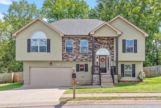 split foyer home with a front yard and a garage