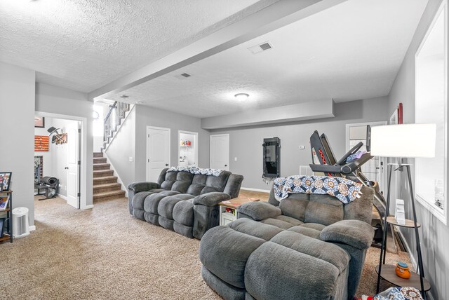 carpeted living room featuring a textured ceiling