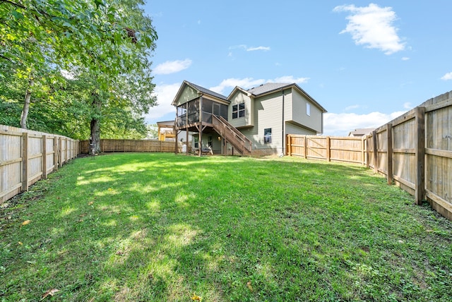 back of house featuring a lawn and a deck