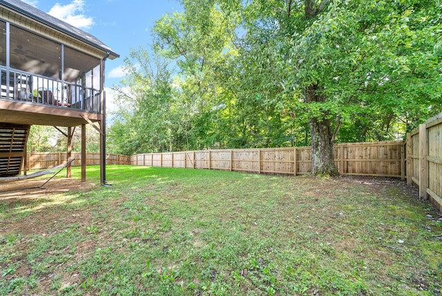 view of yard with a deck and a sunroom