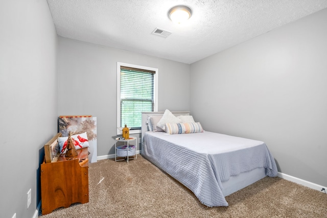 carpeted bedroom featuring a textured ceiling