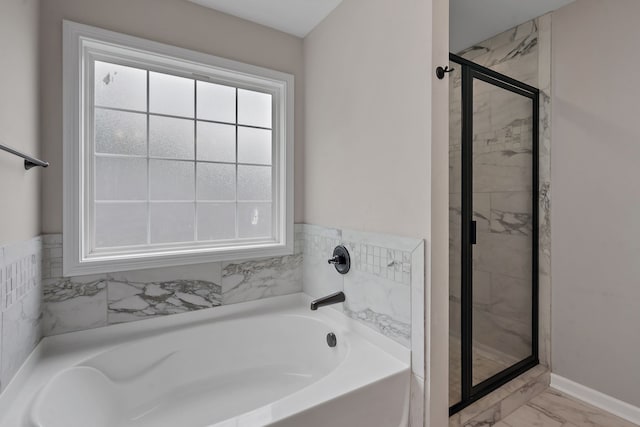 bathroom featuring independent shower and bath