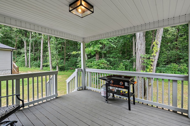 wooden terrace with a yard