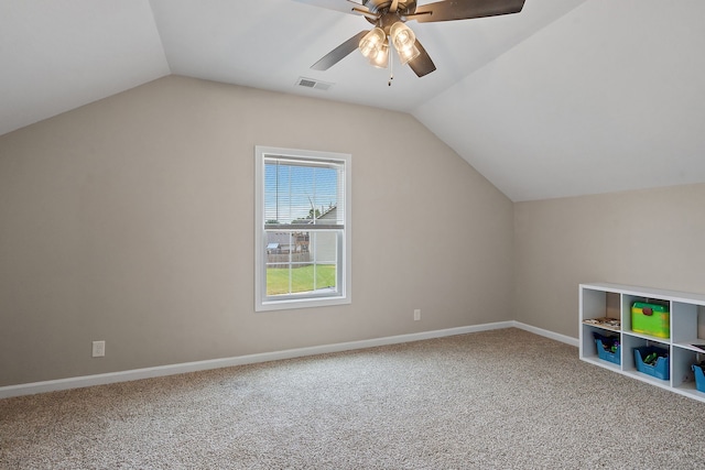 additional living space with ceiling fan, vaulted ceiling, and carpet