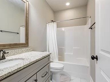 full bathroom featuring shower / bath combination with curtain, vanity, and toilet