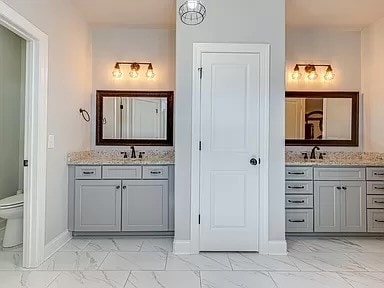 bathroom featuring vanity and toilet