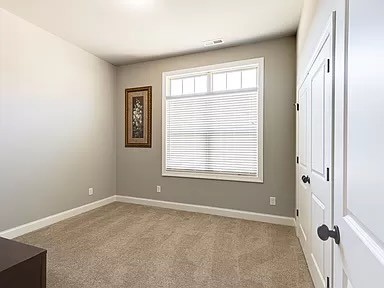 unfurnished room featuring light colored carpet