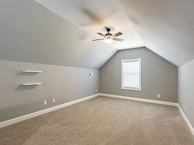 additional living space featuring lofted ceiling, carpet flooring, and ceiling fan