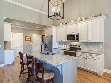 kitchen with white cabinets, appliances with stainless steel finishes, and sink