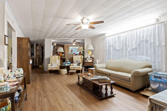 living room featuring ceiling fan and light wood-type flooring