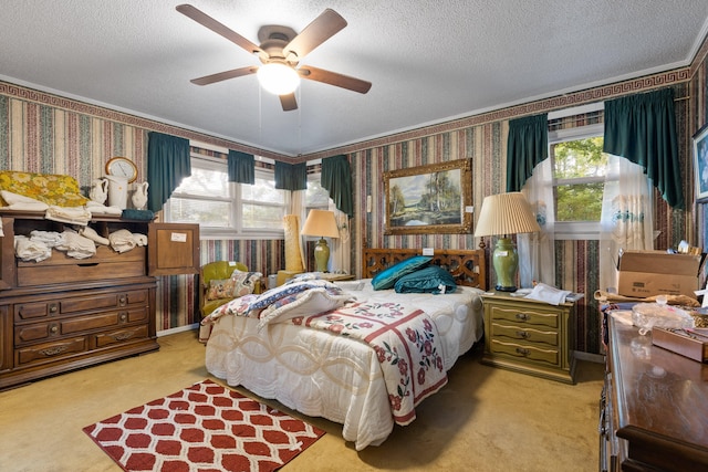 carpeted bedroom featuring multiple windows, ceiling fan, and a textured ceiling