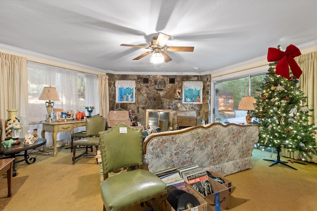 carpeted living room with a textured ceiling, ceiling fan, plenty of natural light, and crown molding