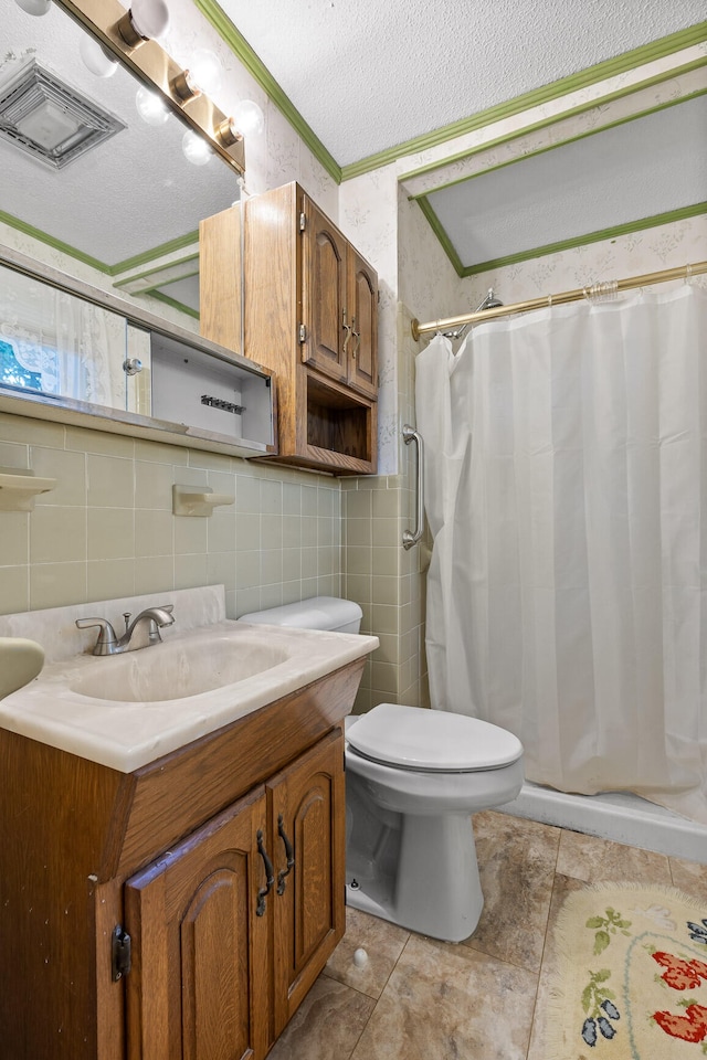 bathroom featuring vanity, toilet, a textured ceiling, a shower with curtain, and tile patterned flooring