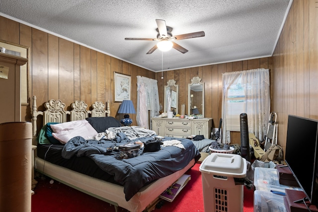 bedroom featuring carpet floors, a textured ceiling, wood walls, and ceiling fan