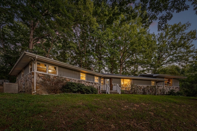 ranch-style house featuring central AC and a yard