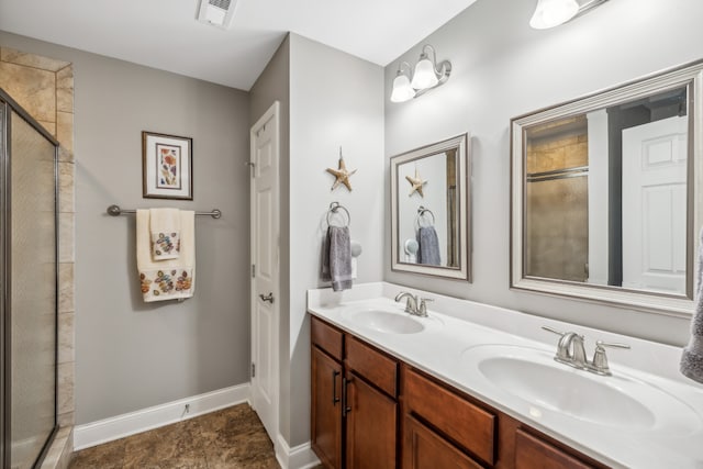 bathroom with vanity, a shower with shower door, and tile patterned floors