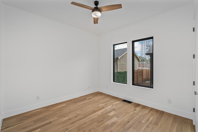 empty room with ceiling fan and light hardwood / wood-style floors