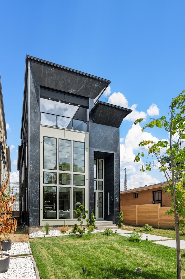 rear view of property featuring a yard