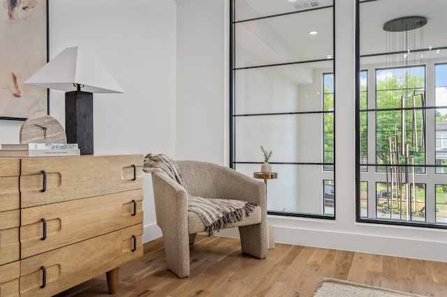 sitting room with wood-type flooring