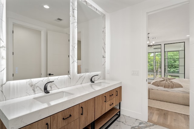 bathroom featuring vanity and a chandelier