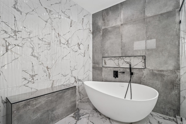 bathroom featuring tile walls and a tub