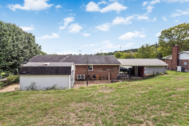 back of house featuring a patio, central AC, and a yard