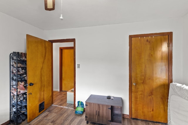 bedroom featuring a closet and dark wood-type flooring