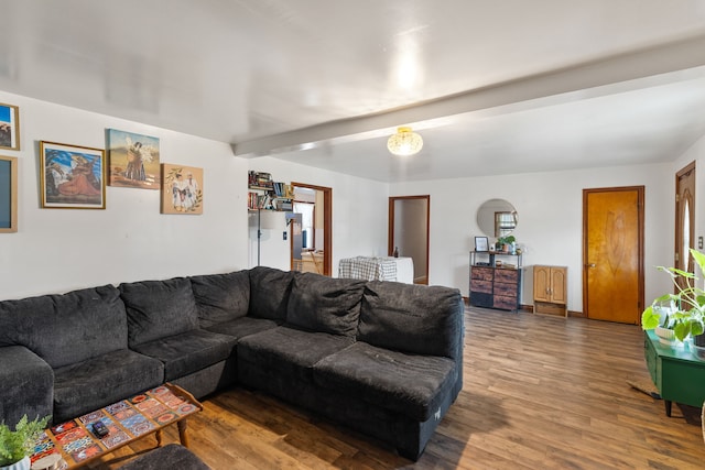 living room with beamed ceiling and hardwood / wood-style flooring