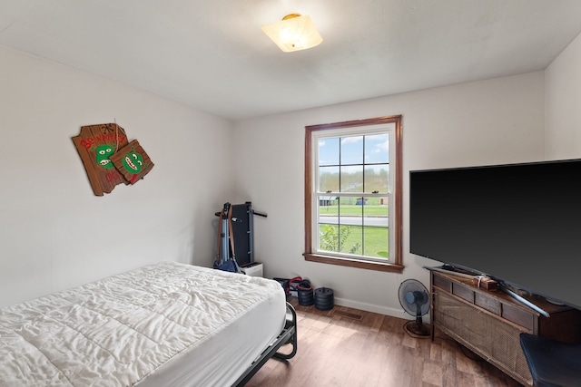 bedroom with hardwood / wood-style flooring