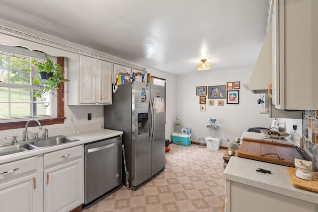 kitchen featuring white cabinets, appliances with stainless steel finishes, and sink