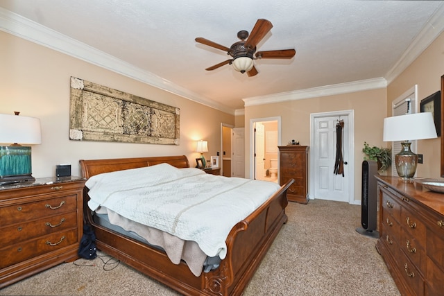 carpeted bedroom with ceiling fan, a textured ceiling, ensuite bath, and ornamental molding