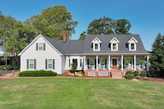 new england style home featuring a front yard and a porch