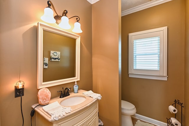 bathroom with vanity, crown molding, toilet, and a textured ceiling