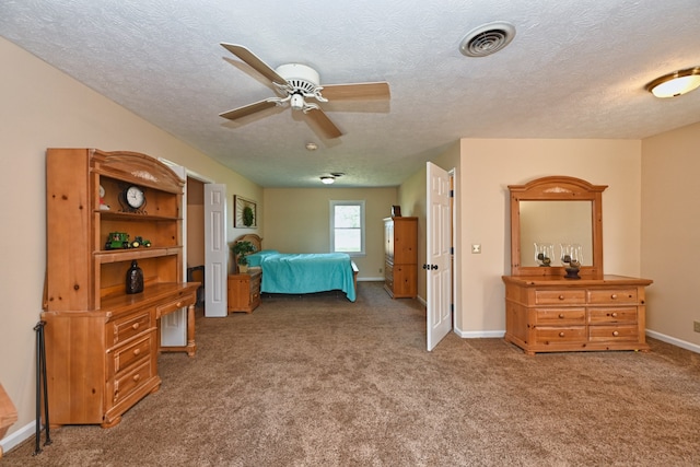 bedroom featuring ceiling fan, carpet floors, and a textured ceiling