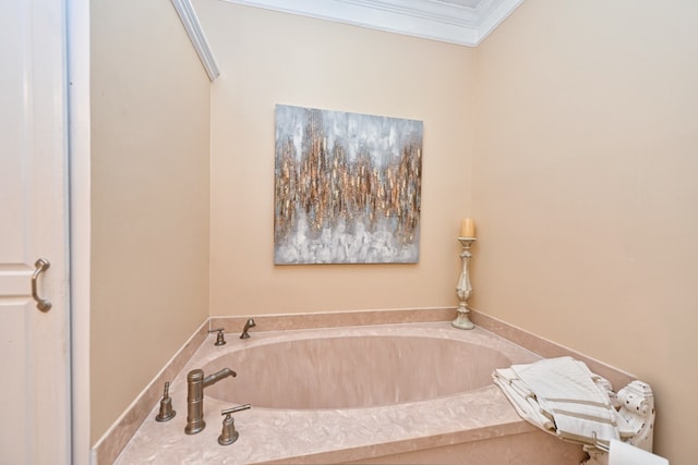 bathroom with a tub and crown molding