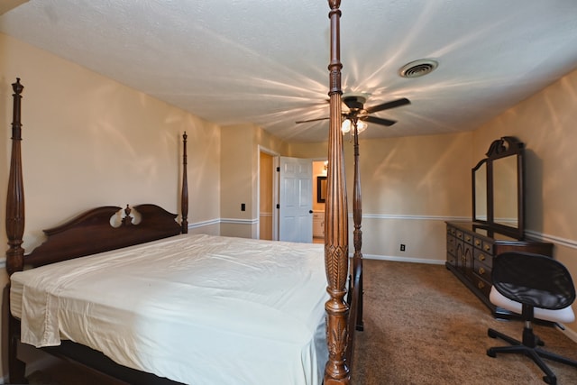 bedroom with a textured ceiling, carpet, and ceiling fan