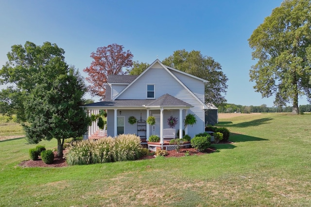 view of front of property featuring covered porch and a front yard