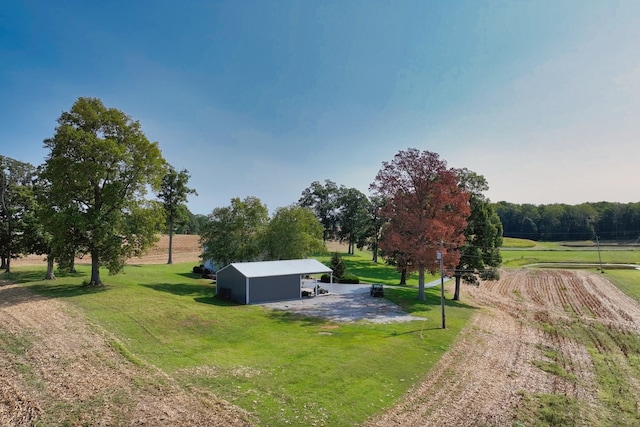 view of yard with a rural view and an outbuilding