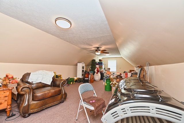 bonus room with carpet floors, a textured ceiling, lofted ceiling, and ceiling fan