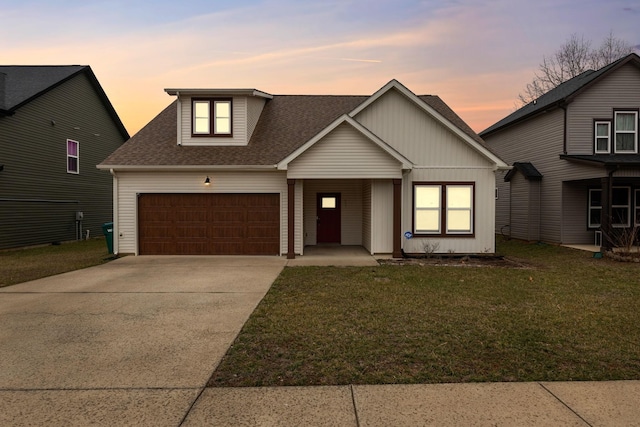 view of front of home featuring a garage and a yard