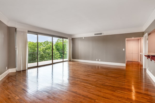 unfurnished room featuring crown molding and dark wood-type flooring