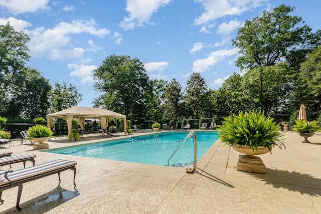 view of swimming pool featuring a patio and a gazebo